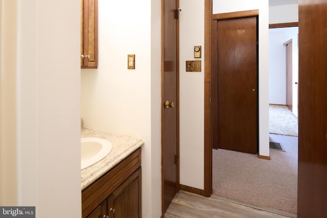 bathroom with vanity, wood finished floors, and visible vents