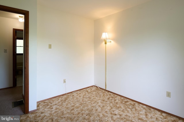 empty room with baseboards, carpet, and visible vents