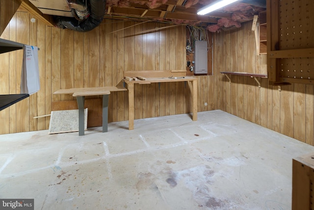 unfinished basement featuring wooden walls and electric panel