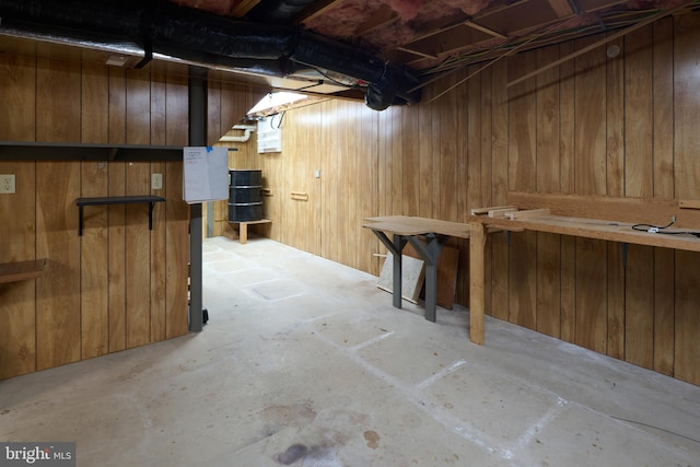 unfinished basement featuring wooden walls