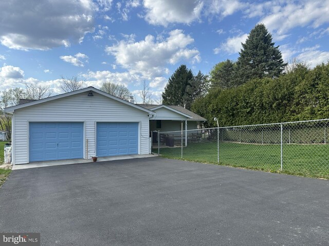 view of front of home with a garage, a front lawn, aphalt driveway, and fence