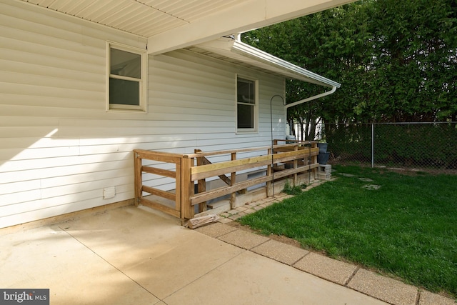 exterior space featuring a lawn, fence, and a patio