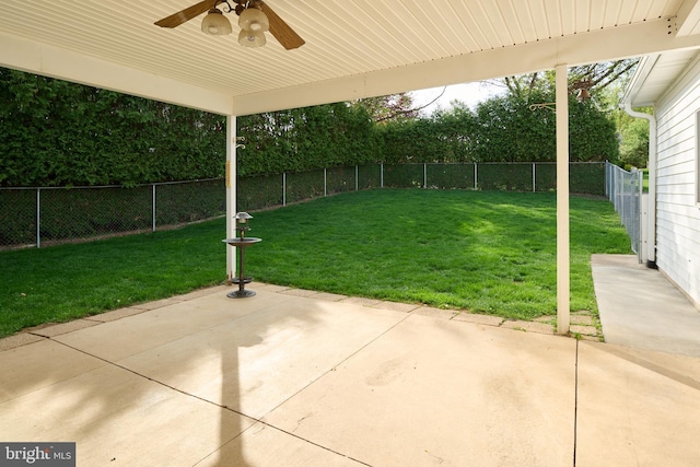 view of yard with a fenced backyard, a ceiling fan, and a patio area