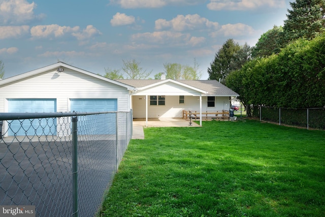 view of front of house with a garage, fence, and a front lawn