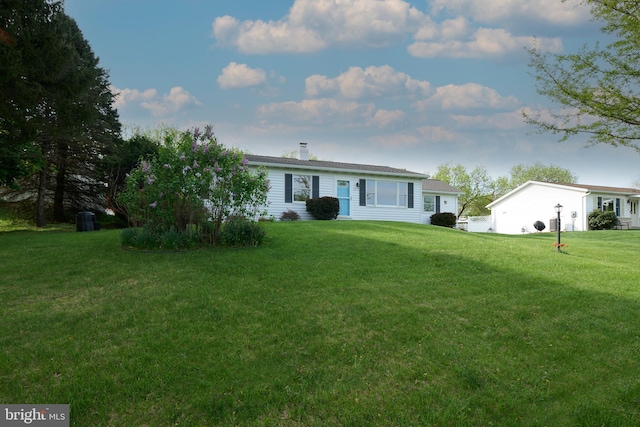 exterior space with a chimney and a front lawn