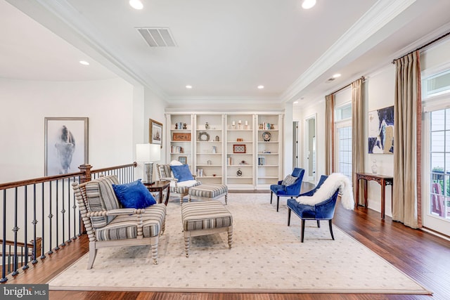 living area featuring recessed lighting, ornamental molding, and visible vents