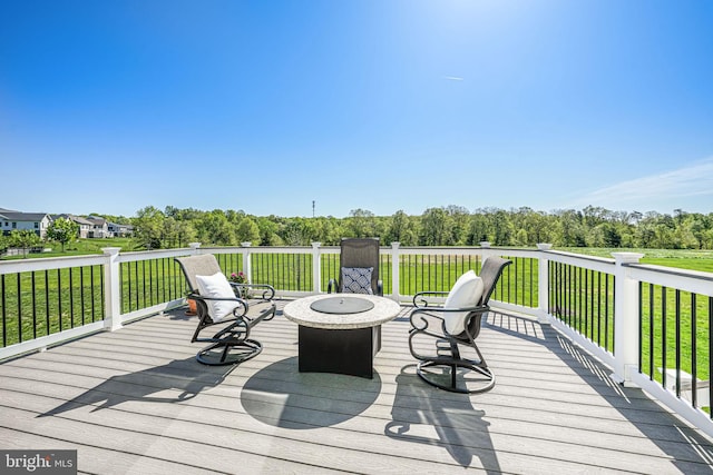 deck featuring a fire pit and a lawn