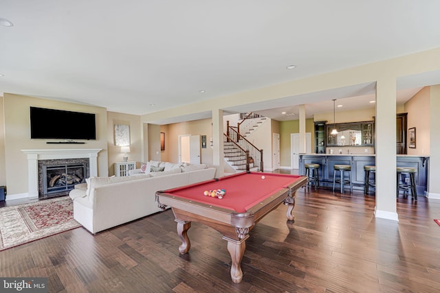 rec room with a premium fireplace, bar area, baseboards, dark wood-type flooring, and billiards