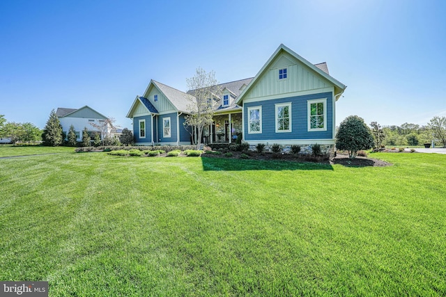 craftsman inspired home with a front yard and board and batten siding