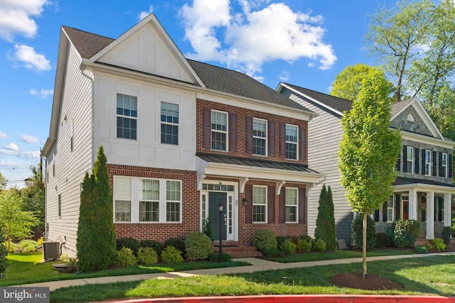 57 Primrose Hill Ln, Annapolis, MD 21403 - view of front of property featuring brick siding, board and batten siding, a front lawn, and central AC unit