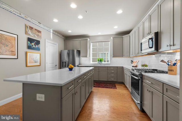 57 Primrose Hill Ln, Annapolis, MD 21403 - kitchen featuring backsplash, light wood finished floors, stainless steel appliances, and gray cabinetry