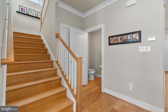 57 Primrose Hill Ln, Annapolis, MD 21403 - stairs featuring wood finished floors, baseboards, and ornamental molding