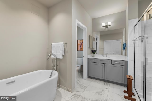 57 Primrose Hill Ln, Annapolis, MD 21403 - bathroom featuring a soaking tub, toilet, baseboards, marble finish floor, and vanity