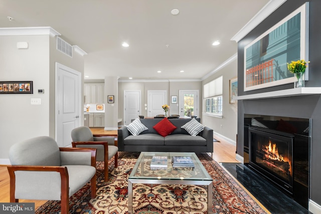 57 Primrose Hill Ln, Annapolis, MD 21403 - living area featuring wood finished floors, visible vents, crown molding, baseboards, and a large fireplace