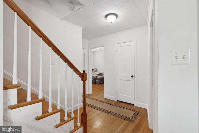entryway with wood-type flooring and stairway