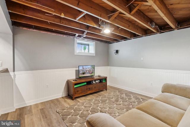 living area featuring wainscoting and wood finished floors