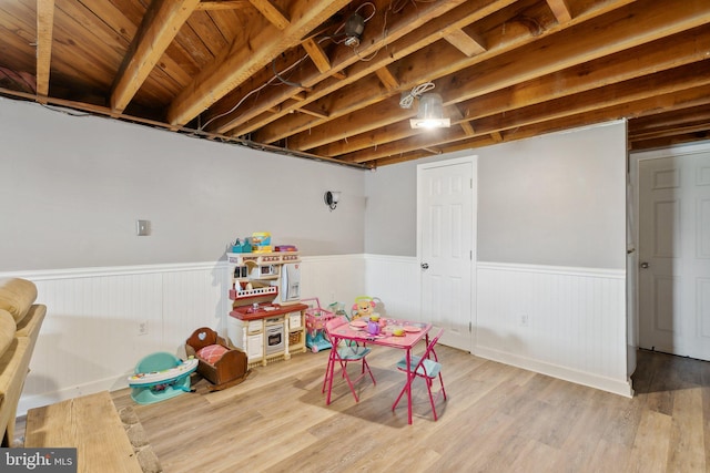 rec room with wainscoting and wood finished floors