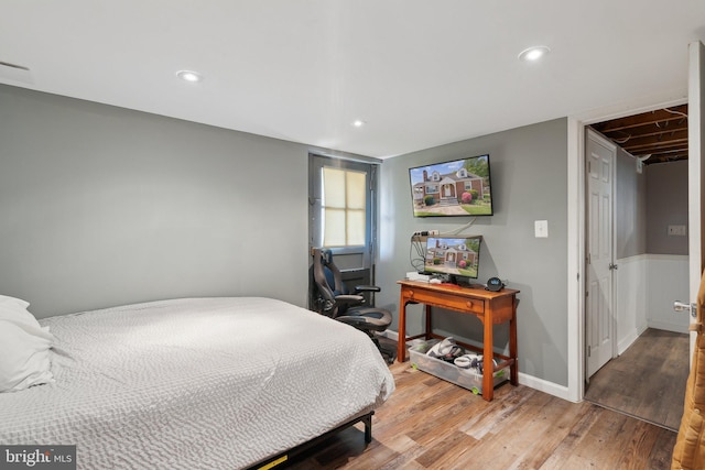 bedroom with recessed lighting, light wood finished floors, baseboards, and visible vents