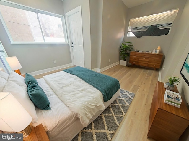 2138 N 18th St, Philadelphia, PA 19121 - bedroom featuring baseboards, multiple windows, and wood finished floors