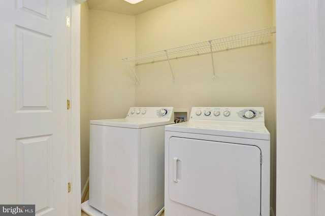 laundry room featuring laundry area and washing machine and clothes dryer