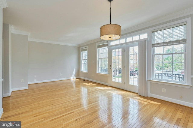 interior space with crown molding, baseboards, and light wood-type flooring