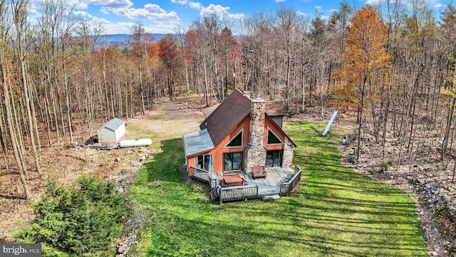 birds eye view of property featuring a view of trees