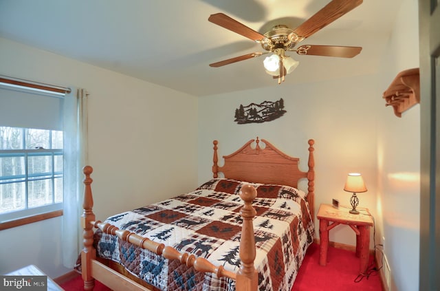 carpeted bedroom featuring a ceiling fan and baseboards