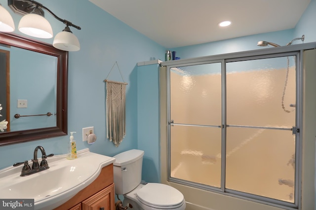 full bathroom with vanity, recessed lighting, enclosed tub / shower combo, and toilet