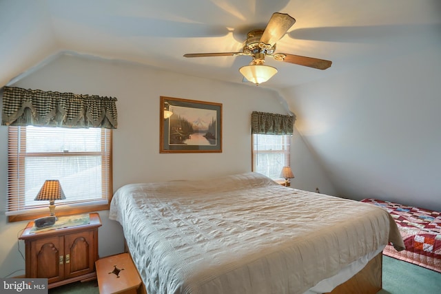 carpeted bedroom featuring ceiling fan and vaulted ceiling