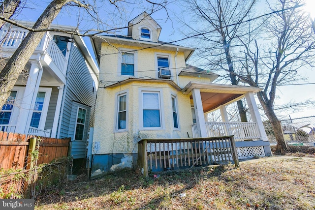 1921 Rhode Island Ave NE, Washington, DC 20018 - view of front of property with stucco siding, covered porch, and fence
