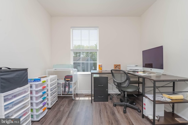 office space featuring baseboards and wood finished floors