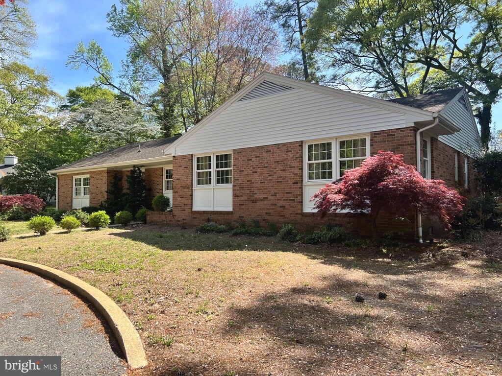view of property exterior featuring a lawn and brick siding