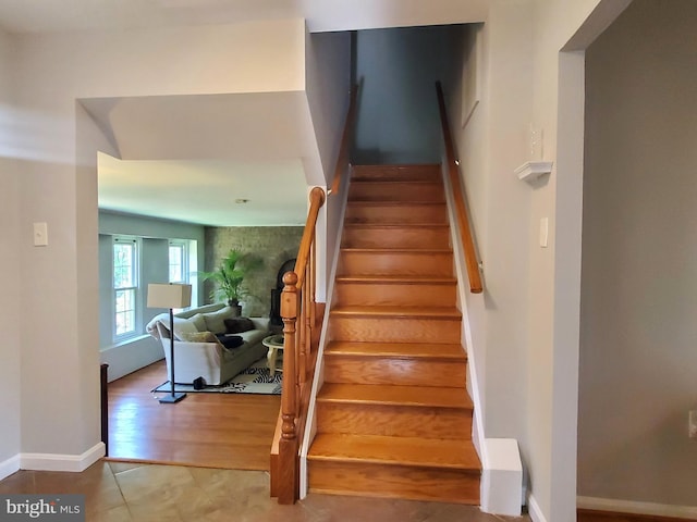 stairs with baseboards and tile patterned flooring