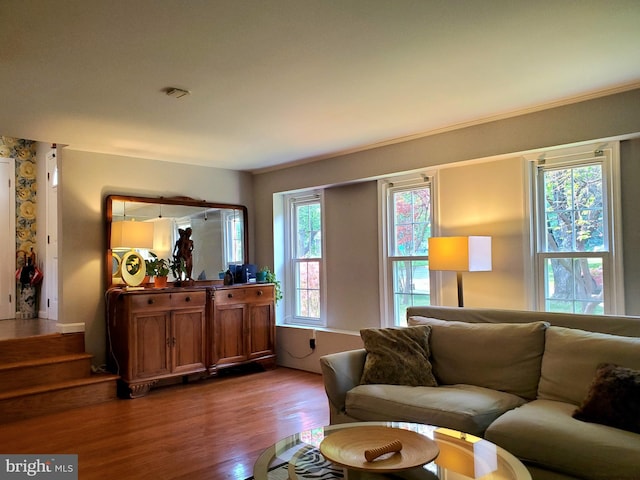 living area with wood finished floors and stairway