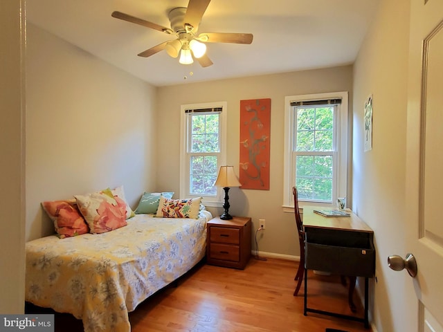 bedroom featuring baseboards, ceiling fan, and light wood finished floors