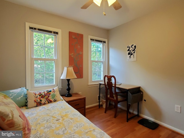 bedroom with baseboards and light wood finished floors