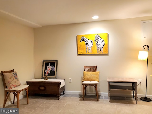 living area featuring baseboards, tile patterned flooring, and recessed lighting