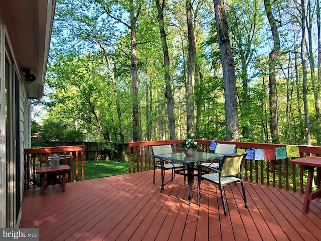 deck with outdoor dining area