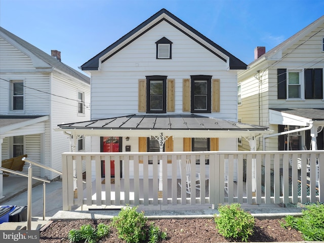 back of property with a porch