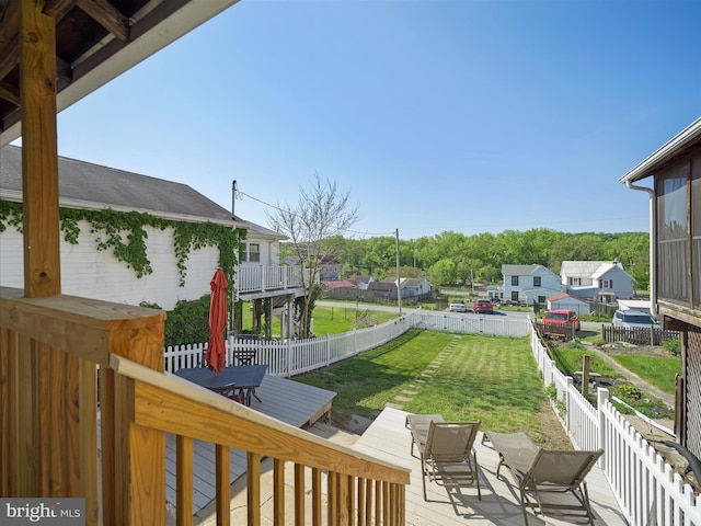 view of yard with a fenced backyard, outdoor dining area, and a deck