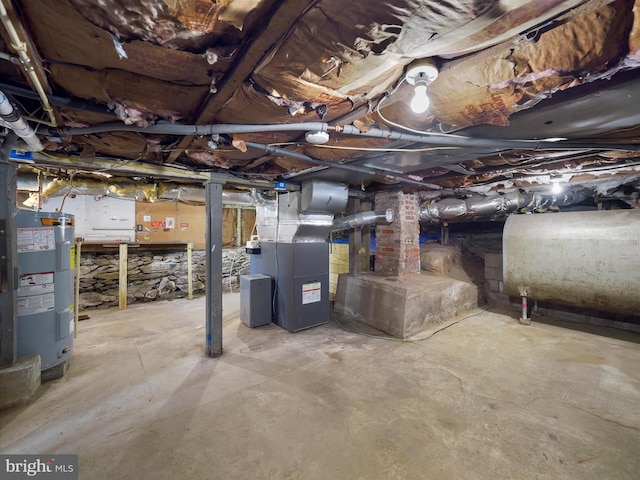 unfinished below grade area featuring heating unit, heating fuel, and water heater
