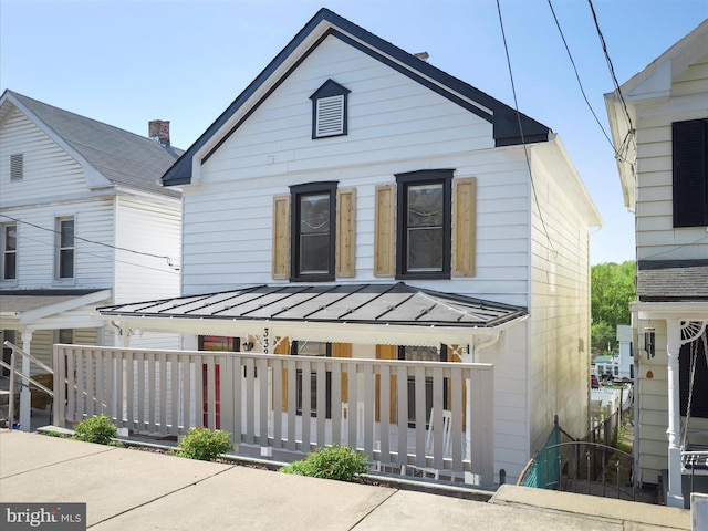 view of front of property with a porch, metal roof, and a standing seam roof