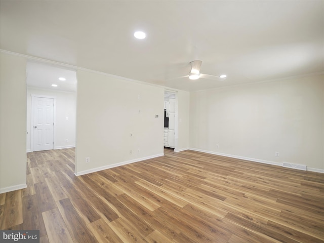 spare room featuring visible vents, ornamental molding, wood finished floors, and recessed lighting