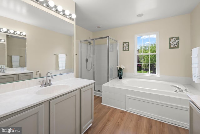 13423 Fairland Park Dr, Silver Spring, MD 20904 - full bathroom with vanity, a shower stall, a bath, and wood finished floors