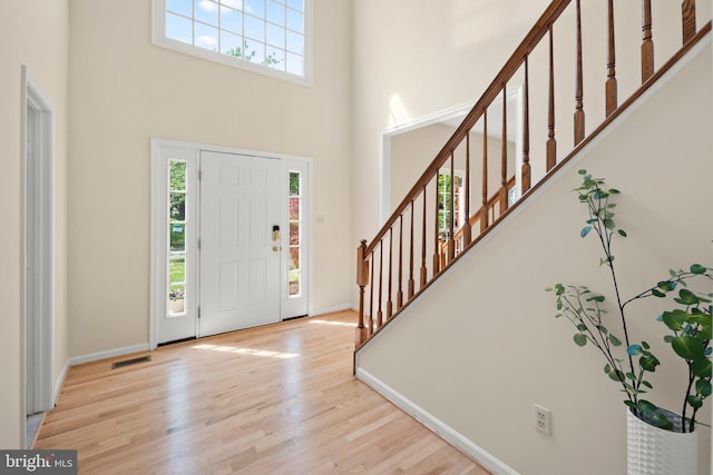 13423 Fairland Park Dr, Silver Spring, MD 20904 - foyer entrance featuring stairs, a high ceiling, baseboards, and wood finished floors