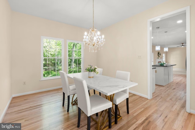 13423 Fairland Park Dr, Silver Spring, MD 20904 - dining space with light wood-style floors, baseboards, and a notable chandelier