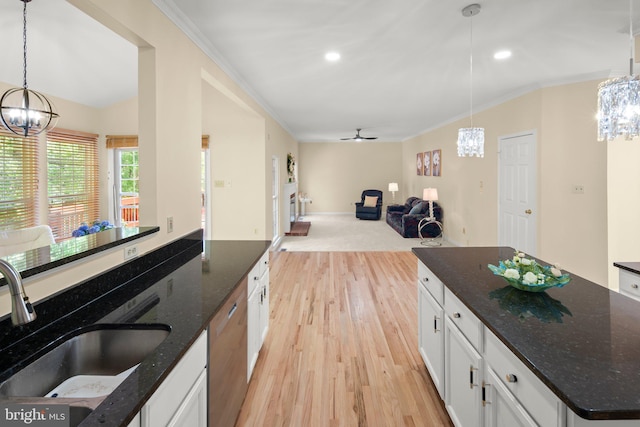 13423 Fairland Park Dr, Silver Spring, MD 20904 - kitchen with stainless steel dishwasher, a sink, an inviting chandelier, ornamental molding, and light wood-style flooring