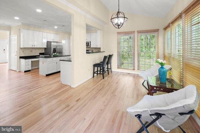 13423 Fairland Park Dr, Silver Spring, MD 20904 - kitchen with dark countertops, white cabinets, appliances with stainless steel finishes, a notable chandelier, and decorative light fixtures