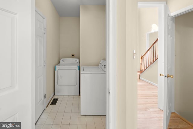 13423 Fairland Park Dr, Silver Spring, MD 20904 - clothes washing area with laundry area, visible vents, washing machine and dryer, light tile patterned floors, and baseboards