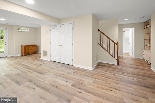 13423 Fairland Park Dr, Silver Spring, MD 20904 - basement with baseboards, light wood finished floors, and stairs